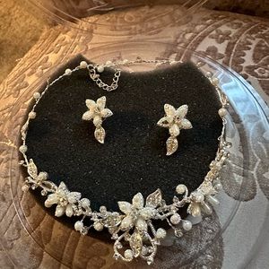 Beautiful bridal necklace and earrings with pearl and rhinestone floral detail.